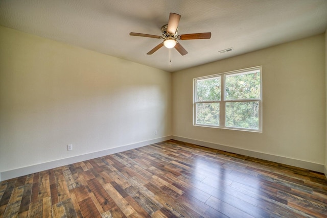 empty room featuring a textured ceiling, ceiling fan, and dark hardwood / wood-style flooring