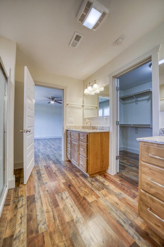 bathroom featuring hardwood / wood-style flooring, vanity, and ceiling fan