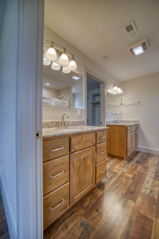 bathroom with vanity and hardwood / wood-style floors