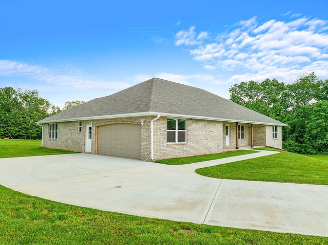 view of front of property with a front yard and a garage