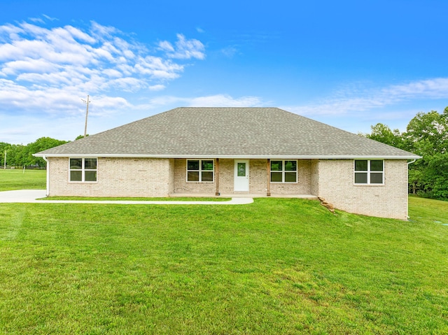 single story home featuring a front lawn and a patio area