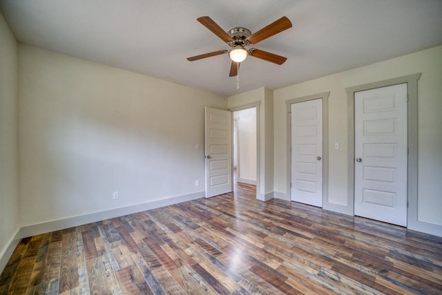 unfurnished bedroom with ceiling fan and dark hardwood / wood-style floors