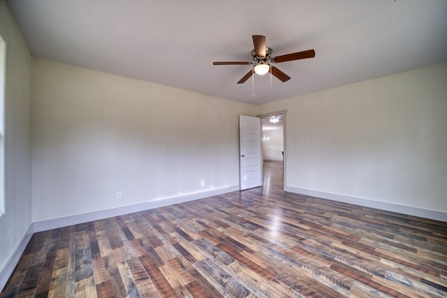 empty room with dark hardwood / wood-style flooring and ceiling fan