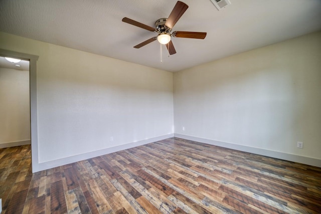 empty room with ceiling fan and dark hardwood / wood-style floors