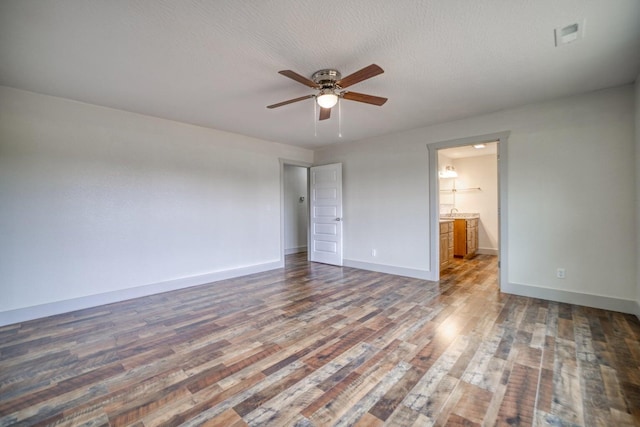 unfurnished room with dark wood-type flooring, a textured ceiling, and ceiling fan