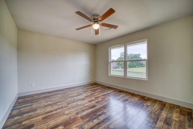 empty room with ceiling fan and dark hardwood / wood-style floors