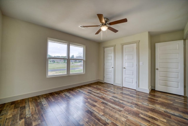 unfurnished bedroom featuring dark hardwood / wood-style floors and ceiling fan