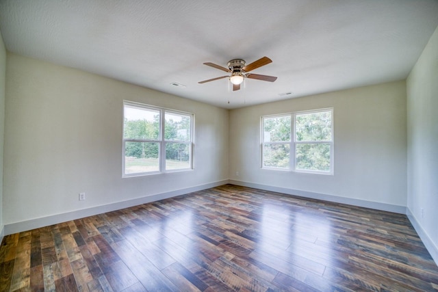 empty room with dark hardwood / wood-style floors, a textured ceiling, and ceiling fan