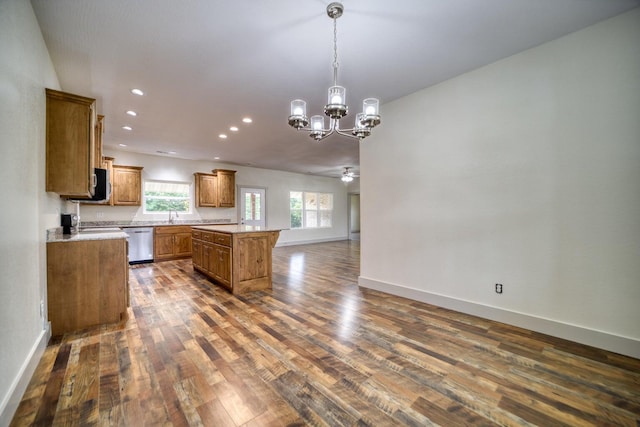 kitchen featuring a center island, sink, dark hardwood / wood-style flooring, ceiling fan with notable chandelier, and dishwasher