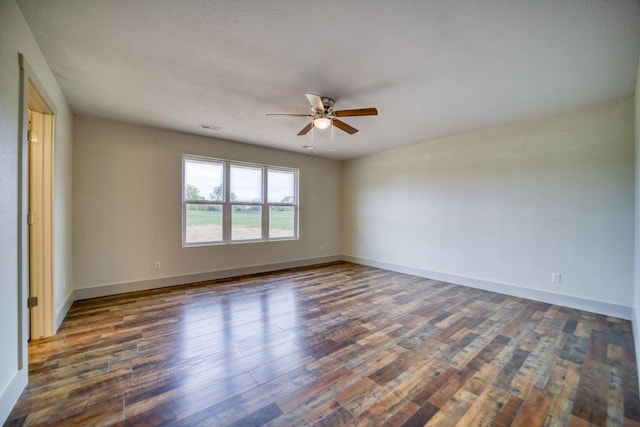 unfurnished room featuring ceiling fan and dark hardwood / wood-style flooring