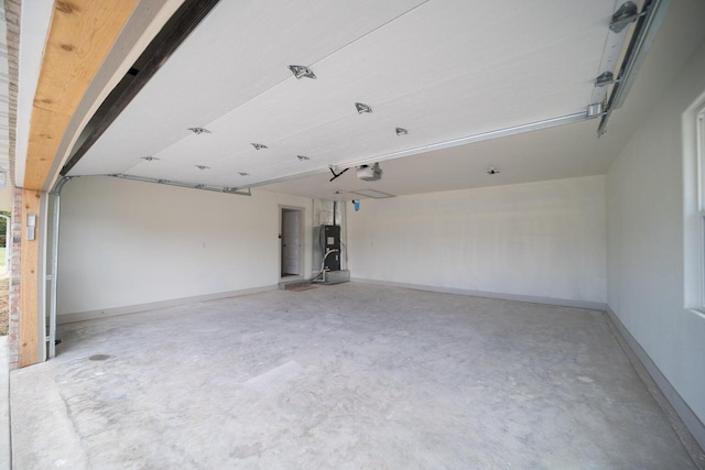 garage with a garage door opener and water heater