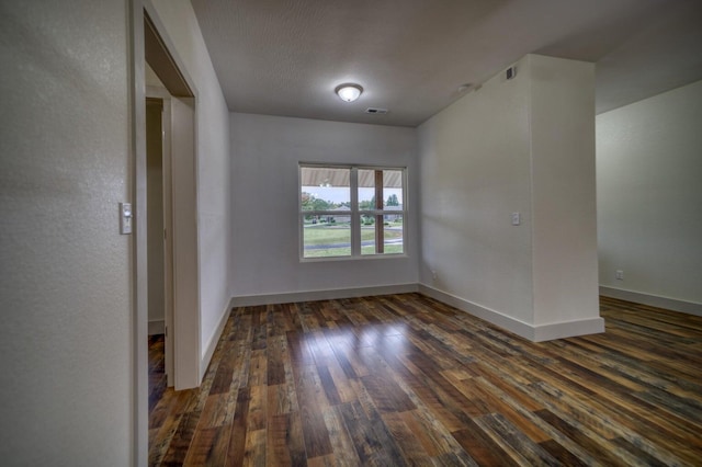 unfurnished room featuring dark hardwood / wood-style flooring