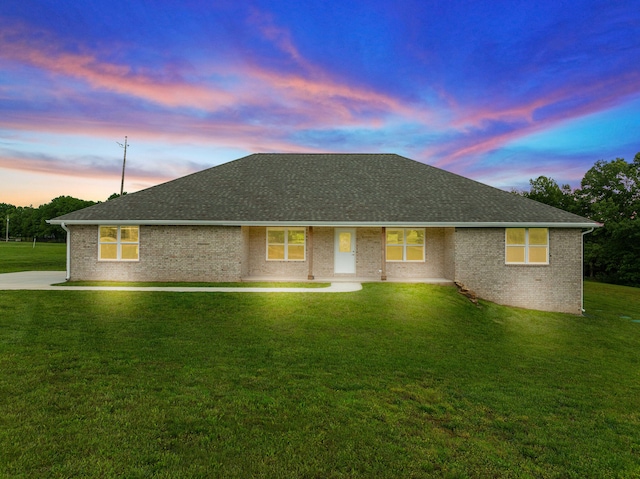 single story home with a yard and a patio