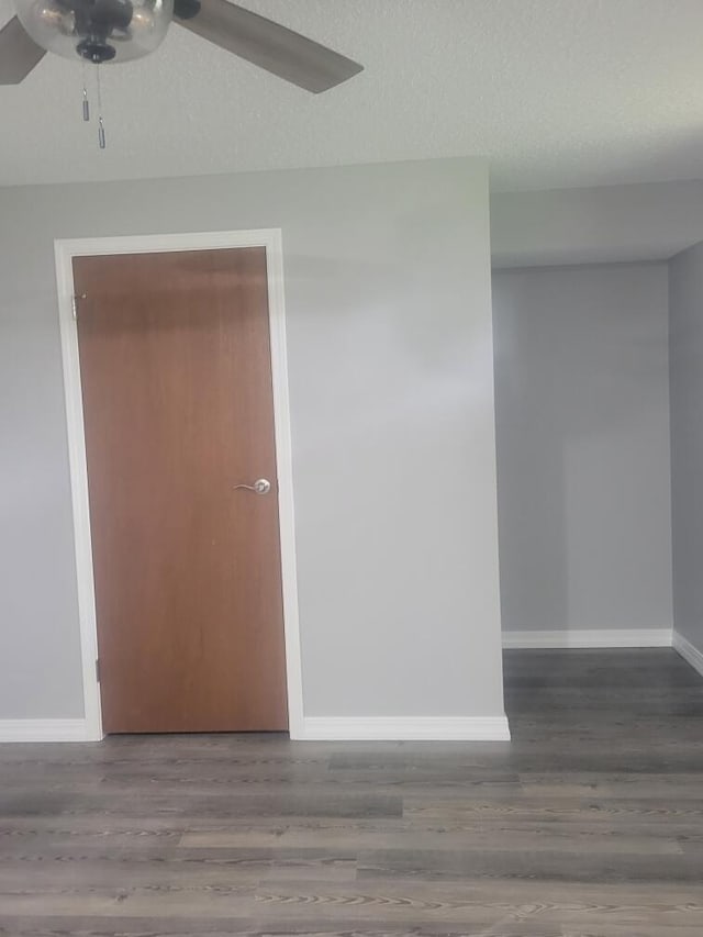 empty room featuring ceiling fan, a textured ceiling, and hardwood / wood-style floors