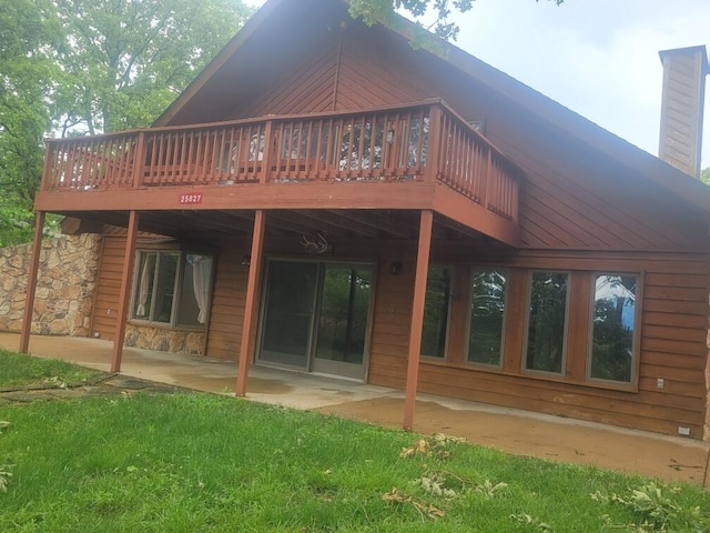 back of house featuring a deck and a patio area