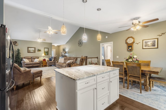 kitchen with pendant lighting, light stone countertops, dark wood-type flooring, and white cabinetry