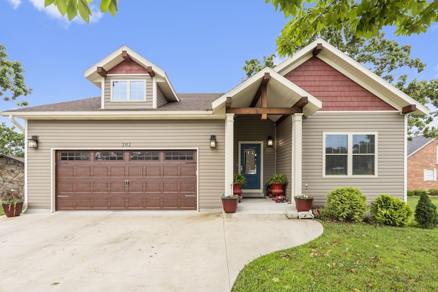 craftsman-style house with a garage and a front lawn