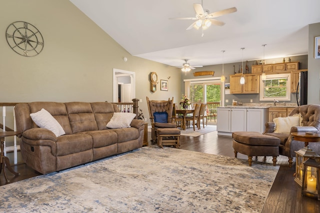 living room with ceiling fan, vaulted ceiling, sink, and dark wood-type flooring