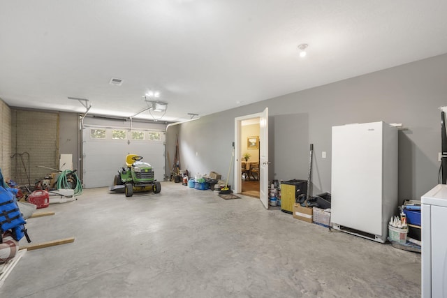 garage with a garage door opener and white fridge