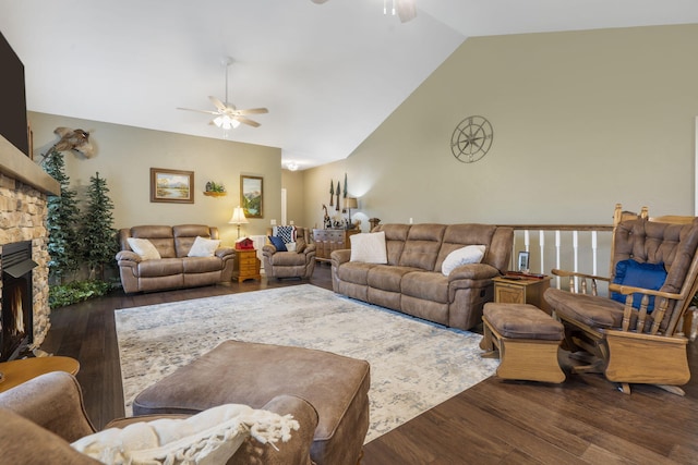 living room featuring lofted ceiling, a fireplace, ceiling fan, and dark wood-type flooring