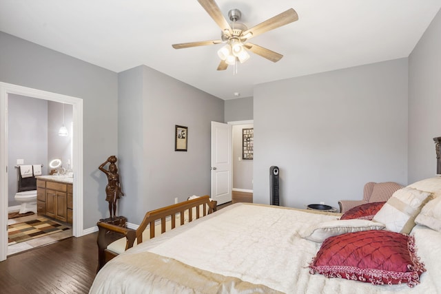 bedroom featuring ensuite bathroom, dark hardwood / wood-style flooring, and ceiling fan