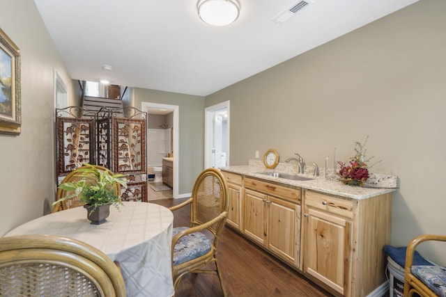 dining space with sink and dark hardwood / wood-style flooring