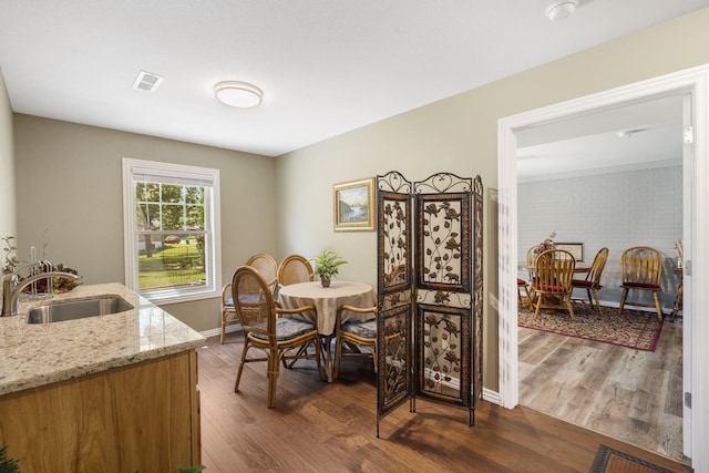 dining room with sink and dark wood-type flooring