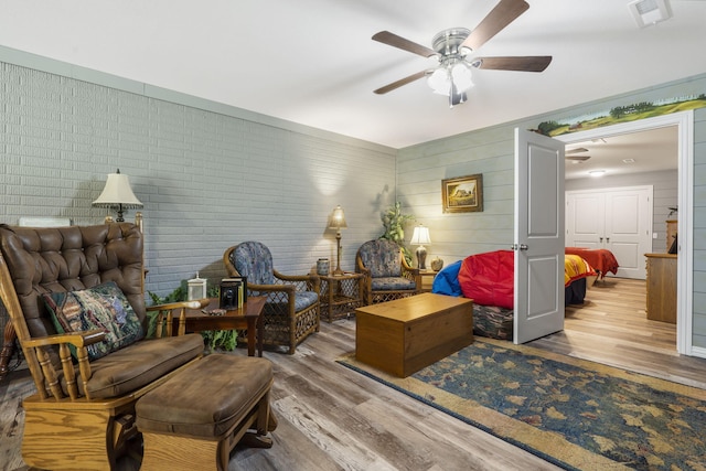 living area with ceiling fan and hardwood / wood-style flooring