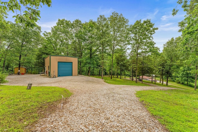 228 Cabin Ln, Kissee Mills, MO 65680 - exterior space with a garage, an outbuilding, and driveway