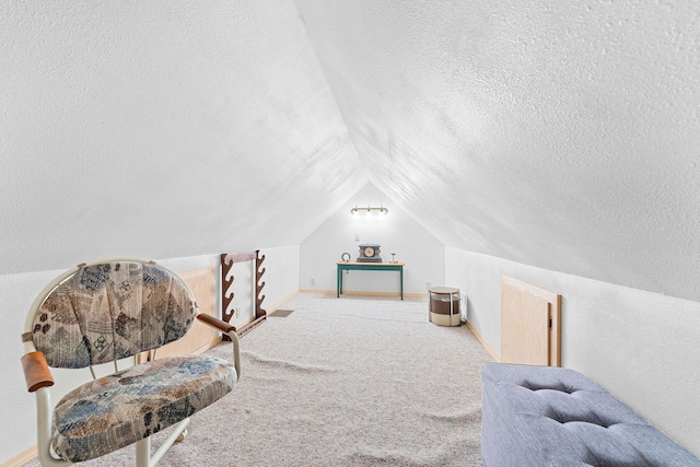 sitting room featuring lofted ceiling, carpet floors, and a textured ceiling