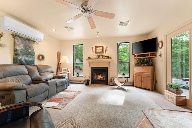 living room with ceiling fan, plenty of natural light, and a wall mounted AC