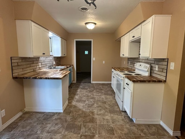 kitchen featuring tasteful backsplash, white appliances, butcher block counters, and white cabinetry