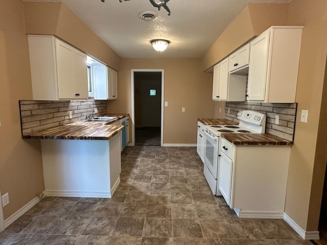 kitchen with white electric range oven, wooden counters, decorative backsplash, baseboards, and visible vents