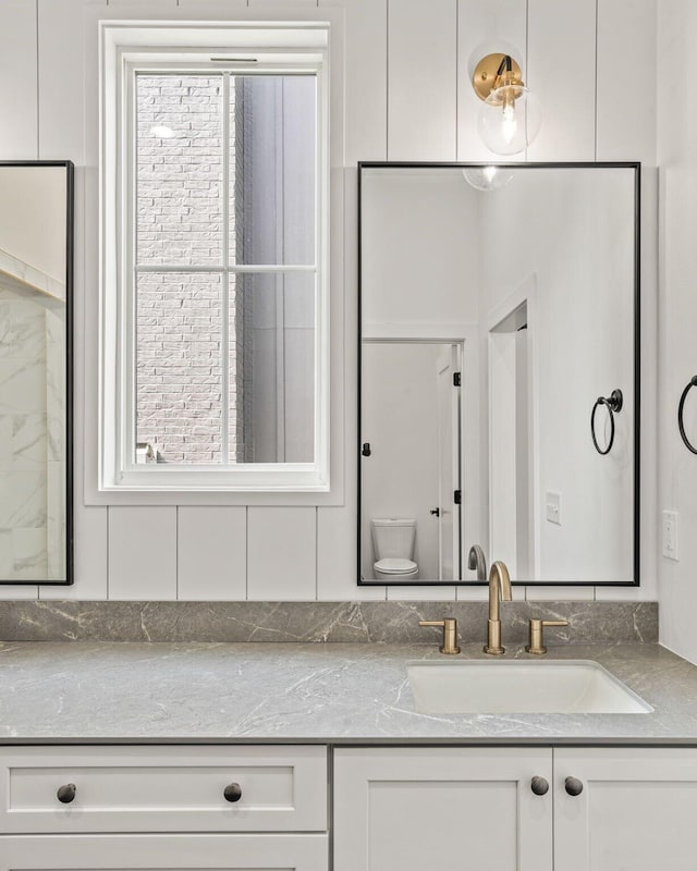 bathroom featuring vanity and toilet