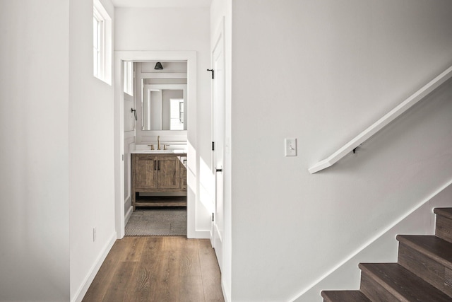 hallway featuring hardwood / wood-style flooring and sink