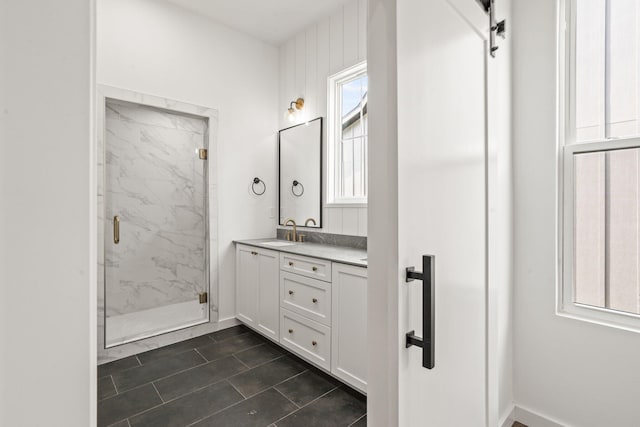 bathroom featuring an enclosed shower and vanity