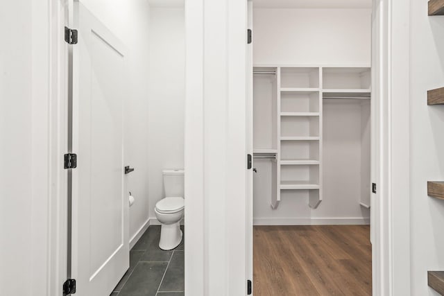 bathroom featuring hardwood / wood-style flooring and toilet