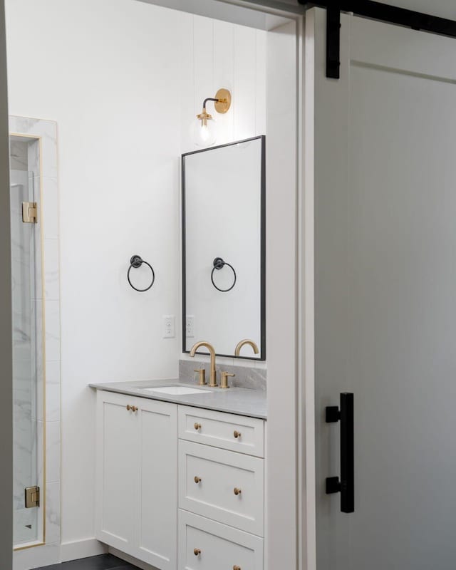 bathroom featuring walk in shower and vanity