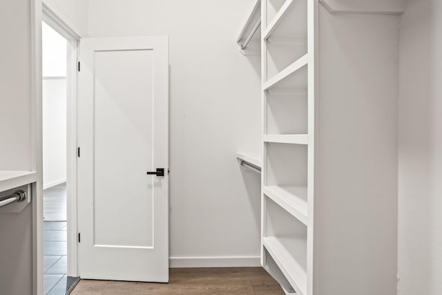 spacious closet featuring hardwood / wood-style floors