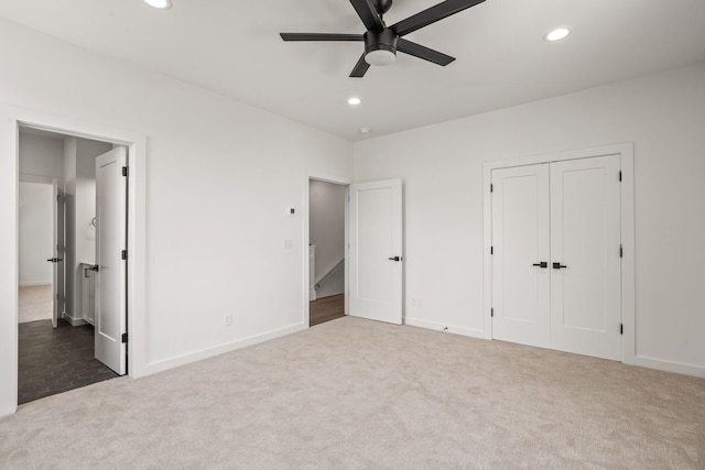 unfurnished bedroom with ceiling fan, a closet, and carpet