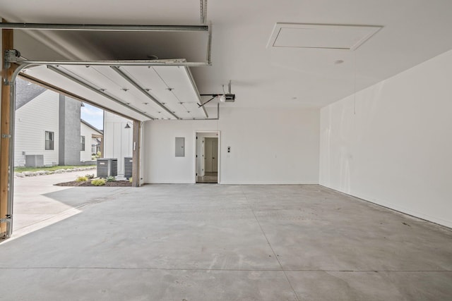 garage featuring a garage door opener, central air condition unit, and electric panel