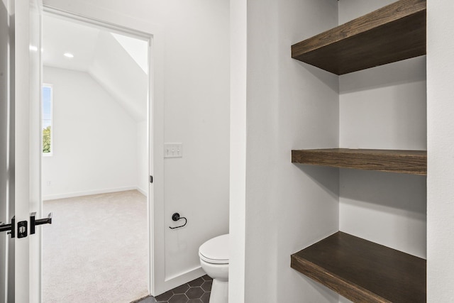 bathroom featuring vaulted ceiling and toilet