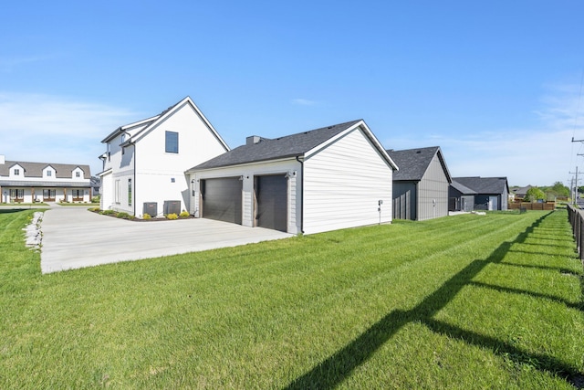 view of side of home with a garage, a yard, and central AC unit