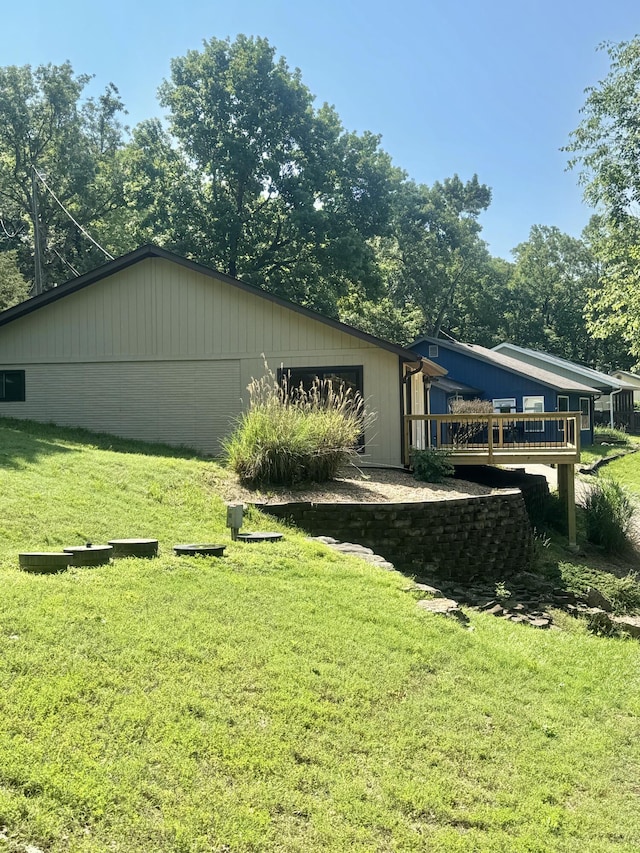 exterior space featuring a wooden deck and a yard