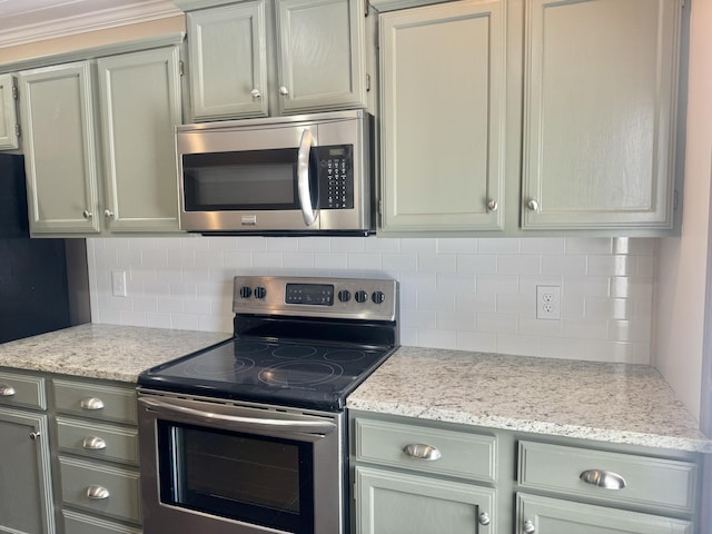 kitchen with tasteful backsplash, light stone countertops, and stainless steel appliances