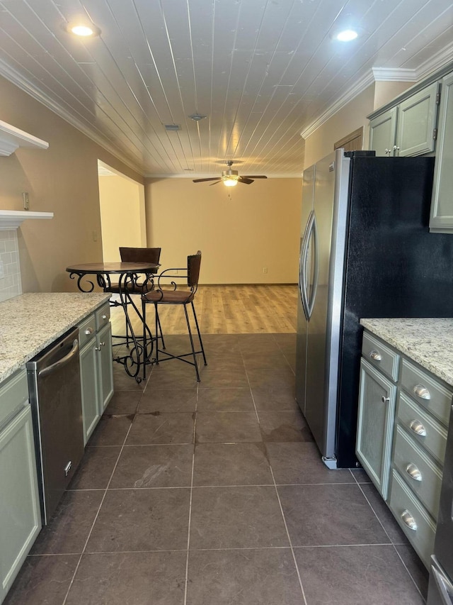 kitchen with stainless steel appliances, recessed lighting, ceiling fan, crown molding, and dark tile patterned floors