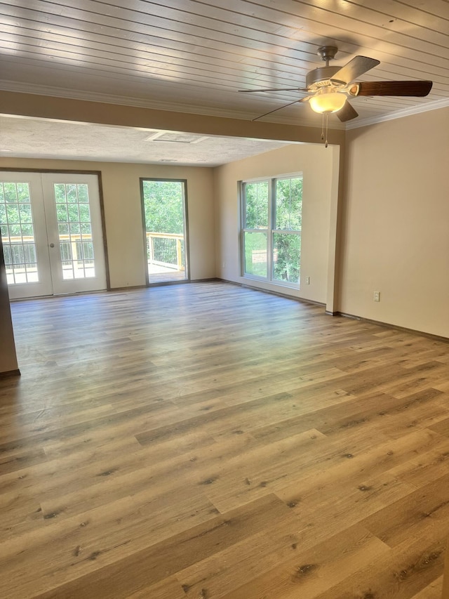 spare room featuring a ceiling fan, wood finished floors, wood ceiling, baseboards, and ornamental molding