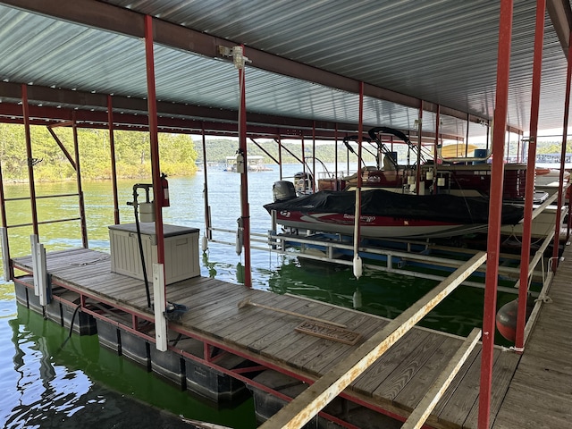 dock area with boat lift and a water view