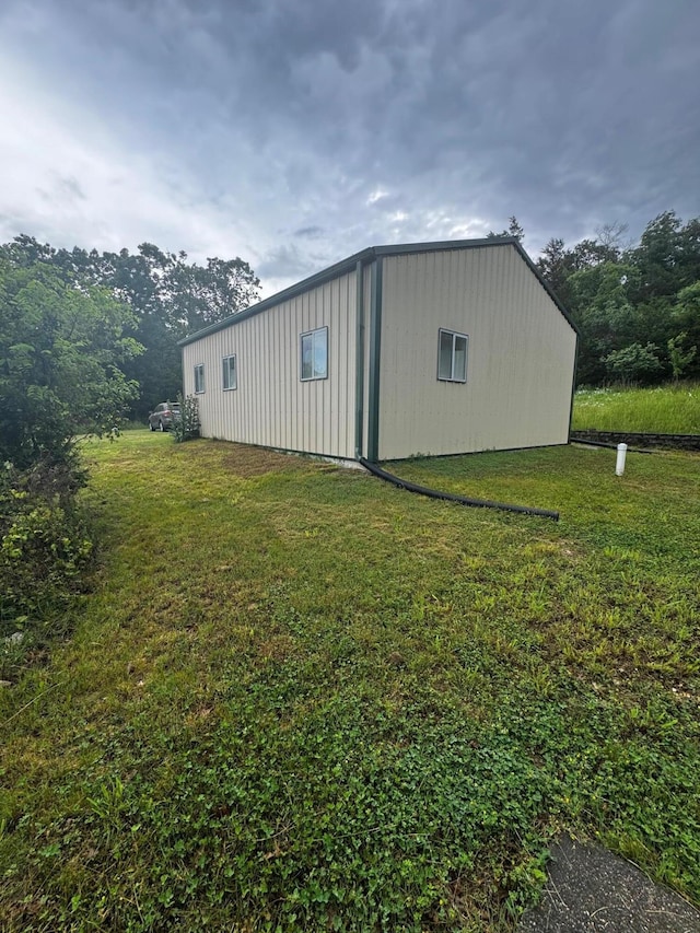 view of outbuilding featuring a lawn