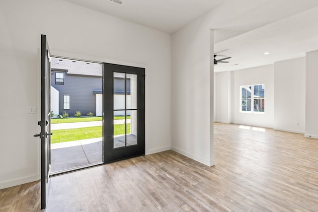 entryway with ceiling fan, light wood-type flooring, and a wealth of natural light